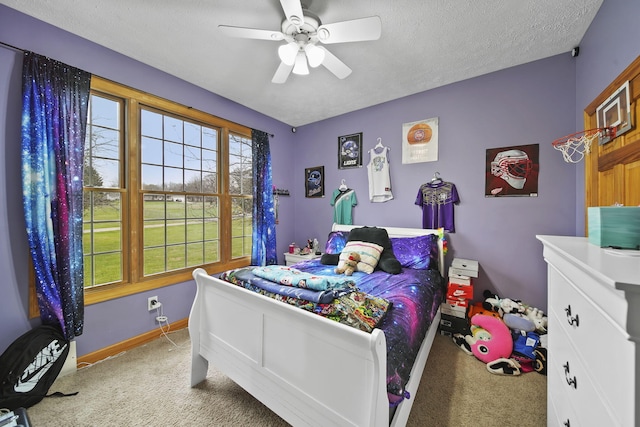 carpeted bedroom featuring a textured ceiling and ceiling fan