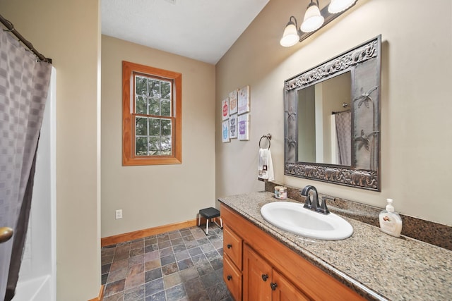 bathroom with a shower with curtain and vanity