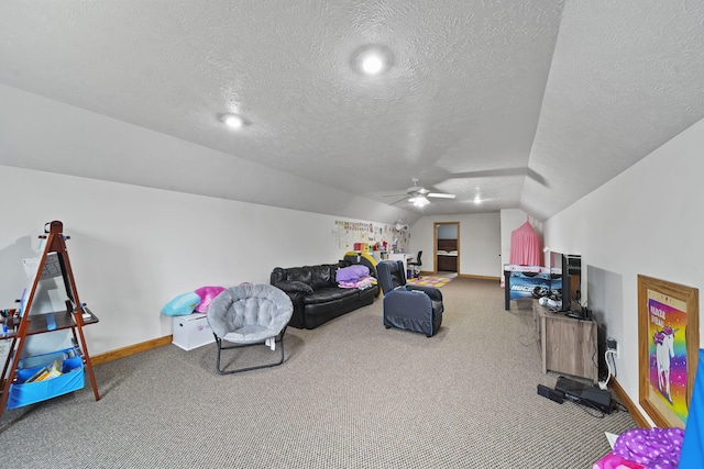 interior space featuring ceiling fan, lofted ceiling, and a textured ceiling