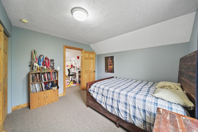 bedroom featuring a textured ceiling, a closet, carpet floors, and lofted ceiling