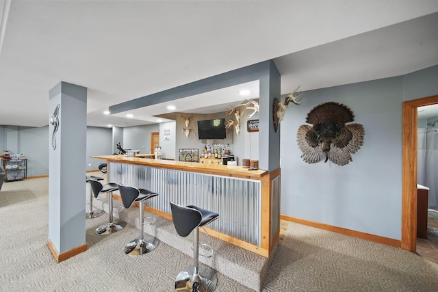 bar with wood counters and light carpet