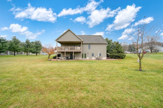 back of property with a lawn and a patio area