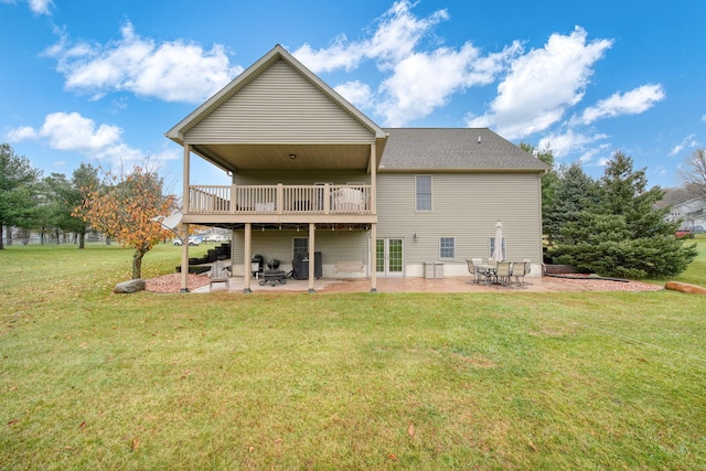 rear view of property with a yard, a patio, and a deck