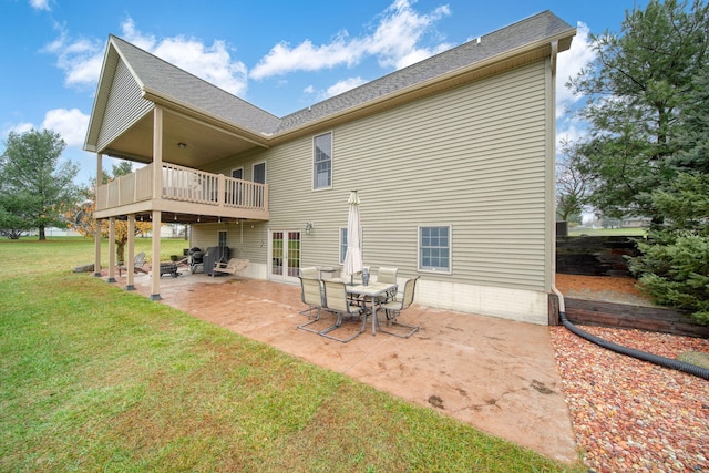 back of property with a yard and a patio area