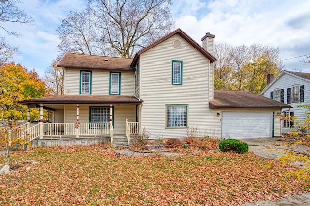 view of property featuring covered porch and a garage