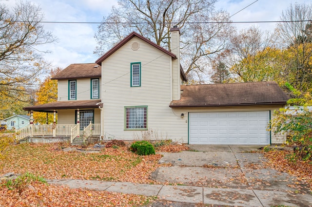 view of front of home with covered porch and a garage