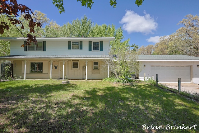 view of front property featuring covered porch, a garage, and a front yard