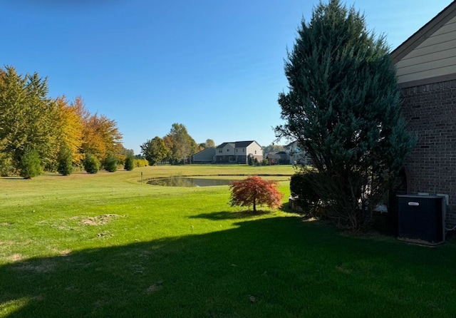 22031 Goldenwillow Dr, Macomb, MI 48044 - view of yard with central AC unit and a water view