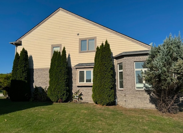 view of property exterior featuring a lawn