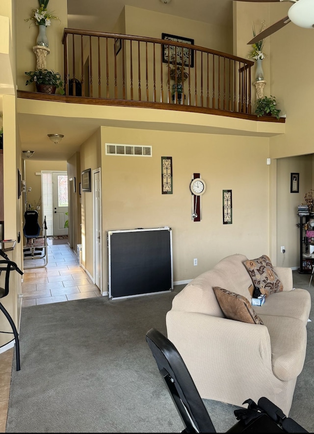 living room featuring a high ceiling and light colored carpet