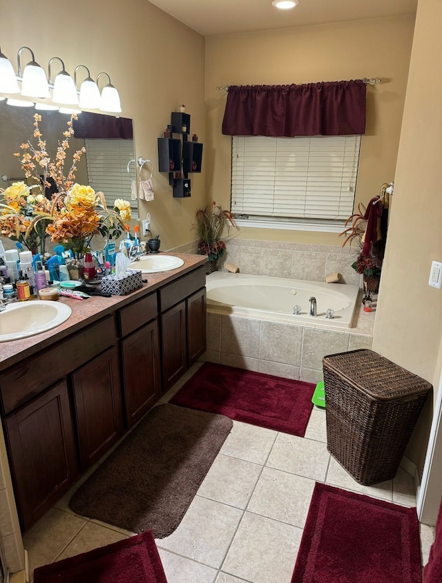 bathroom featuring vanity, tile patterned flooring, and a relaxing tiled tub