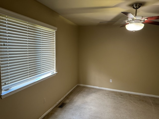 unfurnished room featuring ceiling fan and carpet floors