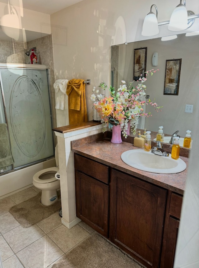 full bathroom with enclosed tub / shower combo, vanity, toilet, and tile patterned flooring