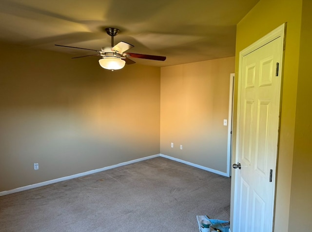 unfurnished room with ceiling fan and light colored carpet