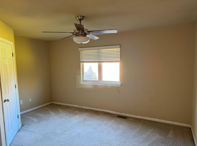 carpeted empty room featuring ceiling fan