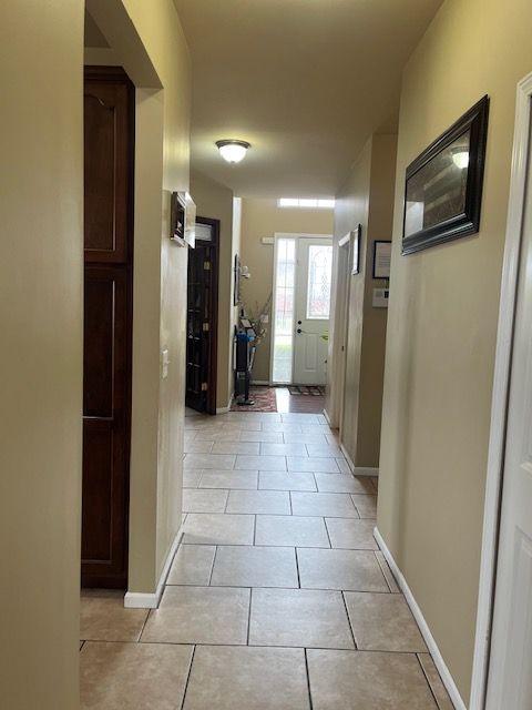 22031 Goldenwillow Dr, Macomb, MI 48044 - hall with baseboards and light tile patterned floors
