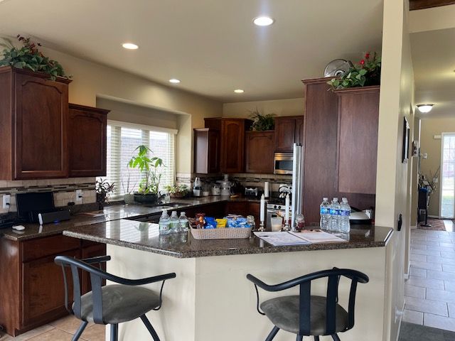 22031 Goldenwillow Dr, Macomb, MI 48044 - kitchen featuring recessed lighting, a peninsula, decorative backsplash, and appliances with stainless steel finishes