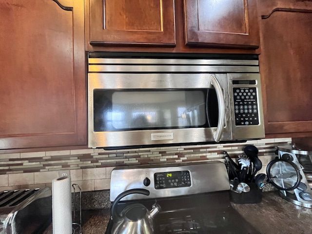 22031 Goldenwillow Dr, Macomb, MI 48044 - interior details featuring backsplash and stainless steel microwave