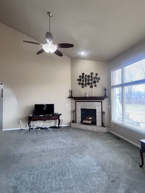 22031 Goldenwillow Dr, Macomb, MI 48044 - unfurnished living room with carpet floors, ceiling fan, a tiled fireplace, and vaulted ceiling