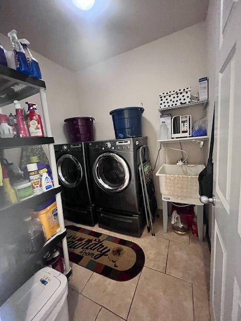 22031 Goldenwillow Dr, Macomb, MI 48044 - washroom featuring a sink, tile patterned floors, laundry area, and independent washer and dryer