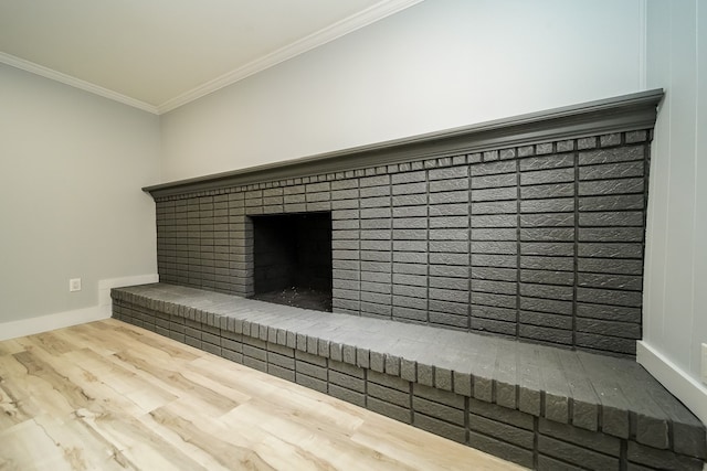 interior details with a fireplace, wood-type flooring, and ornamental molding