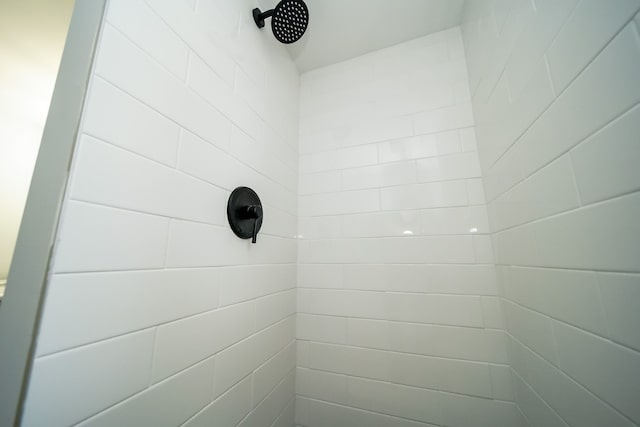 interior details featuring a tile shower