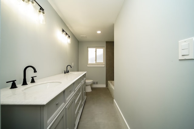 bathroom with concrete flooring, vanity, toilet, and a washtub