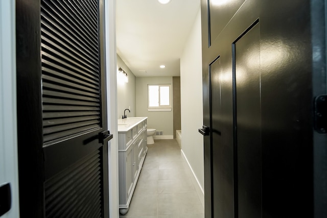 bathroom with a shower, tile patterned floors, vanity, and toilet