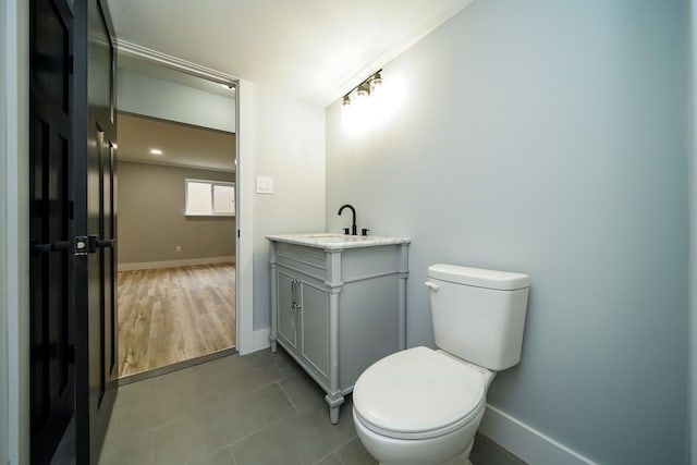 bathroom with tile patterned flooring, vanity, and toilet