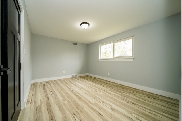 unfurnished room with light wood-type flooring