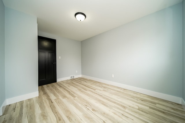 spare room featuring light wood-type flooring