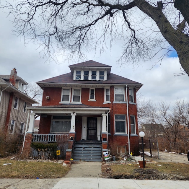 traditional style home with brick siding and a porch