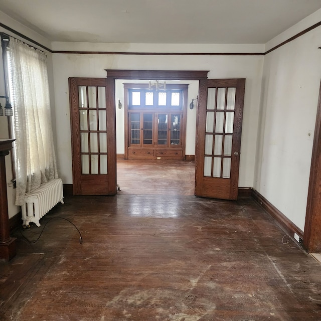 doorway to outside featuring french doors, plenty of natural light, and radiator heating unit