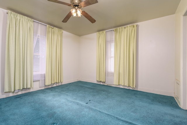 carpeted spare room with ceiling fan