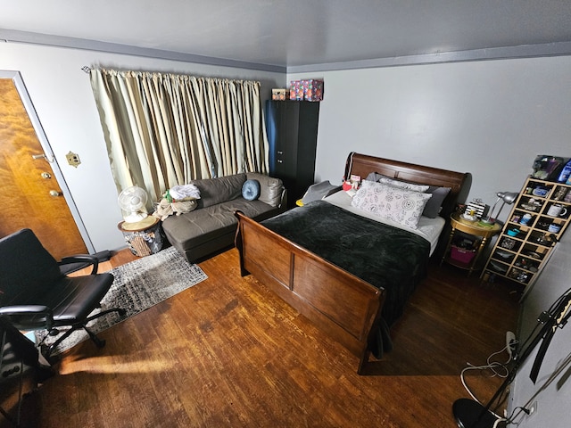 bedroom with dark wood-type flooring