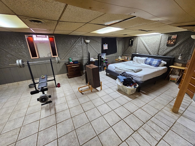 bedroom featuring a paneled ceiling and tile patterned flooring