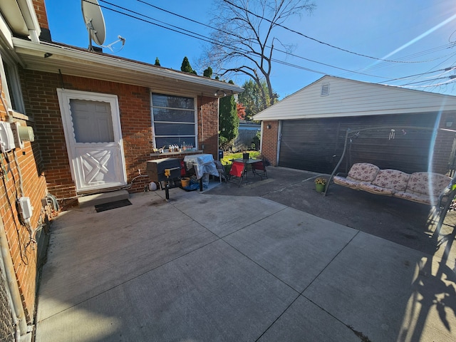 view of patio with a garage and an outdoor structure