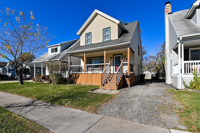 view of front of property with a front lawn and covered porch