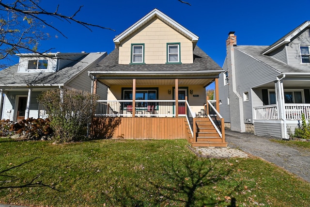 view of front of property featuring covered porch and a front lawn