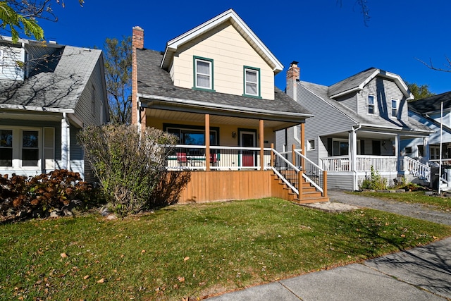 view of front of property with a front lawn and covered porch