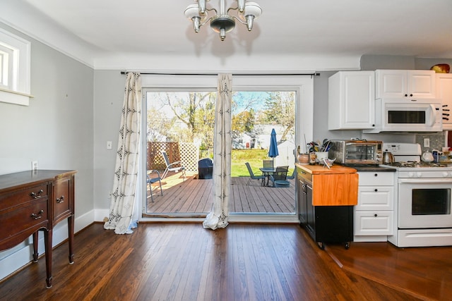 kitchen featuring white cabinetry, dark wood-type flooring, white appliances, and a notable chandelier