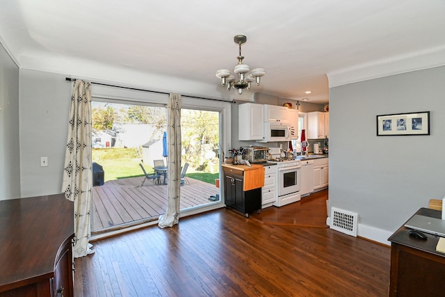 kitchen featuring wood counters, dark hardwood / wood-style flooring, white appliances, pendant lighting, and white cabinets