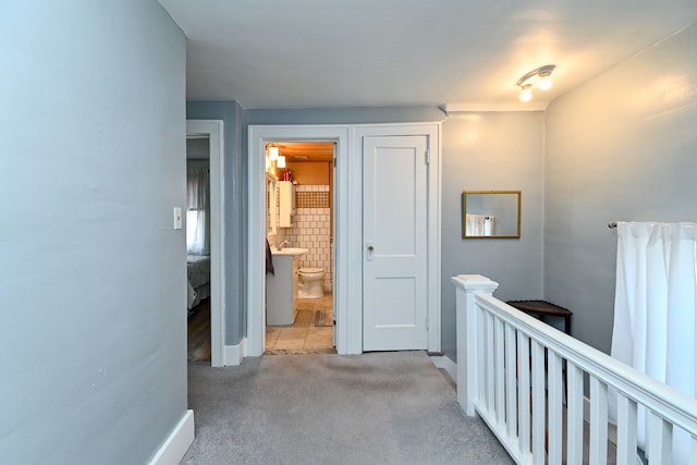 hallway with light colored carpet