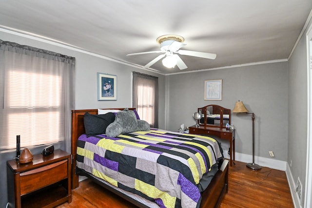 bedroom with dark hardwood / wood-style floors, ceiling fan, and ornamental molding