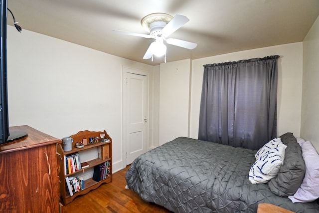 bedroom with ceiling fan and wood-type flooring