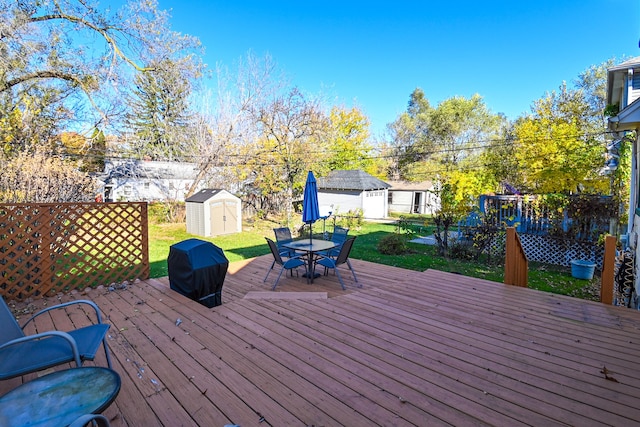 wooden terrace with a yard and a shed