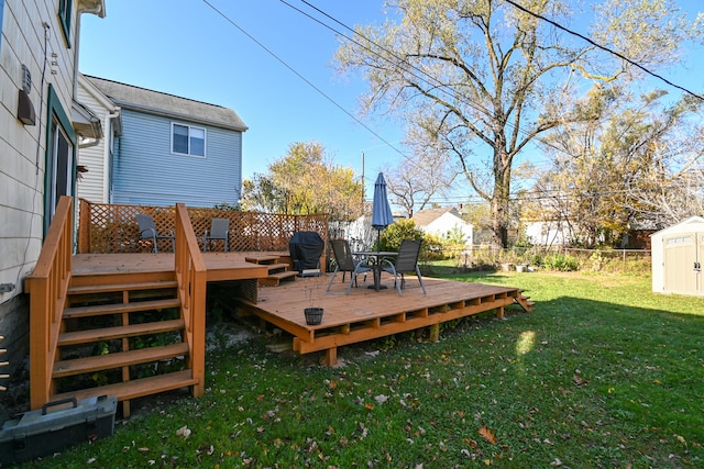 deck with a storage shed and a lawn