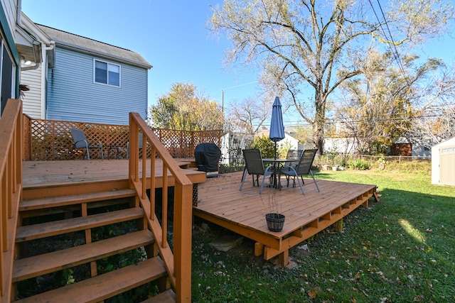 wooden deck featuring a yard