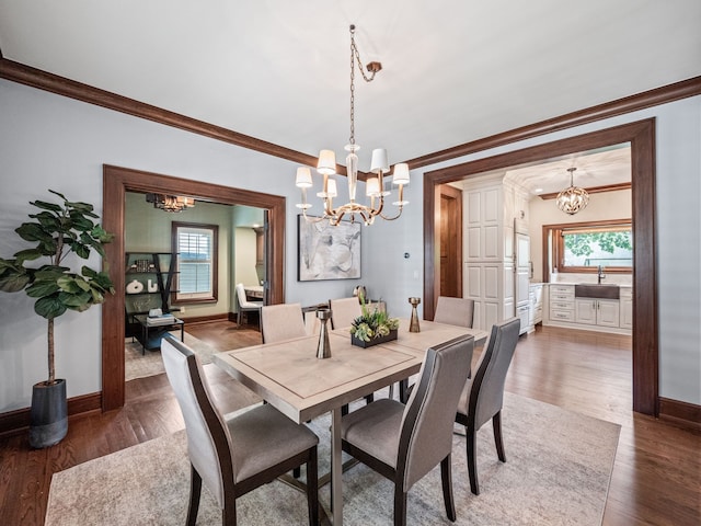 dining area with crown molding, dark hardwood / wood-style flooring, and sink