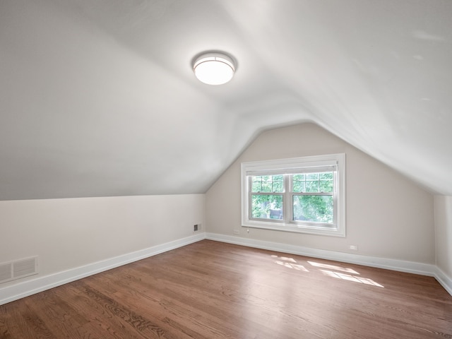 bonus room featuring hardwood / wood-style flooring and lofted ceiling